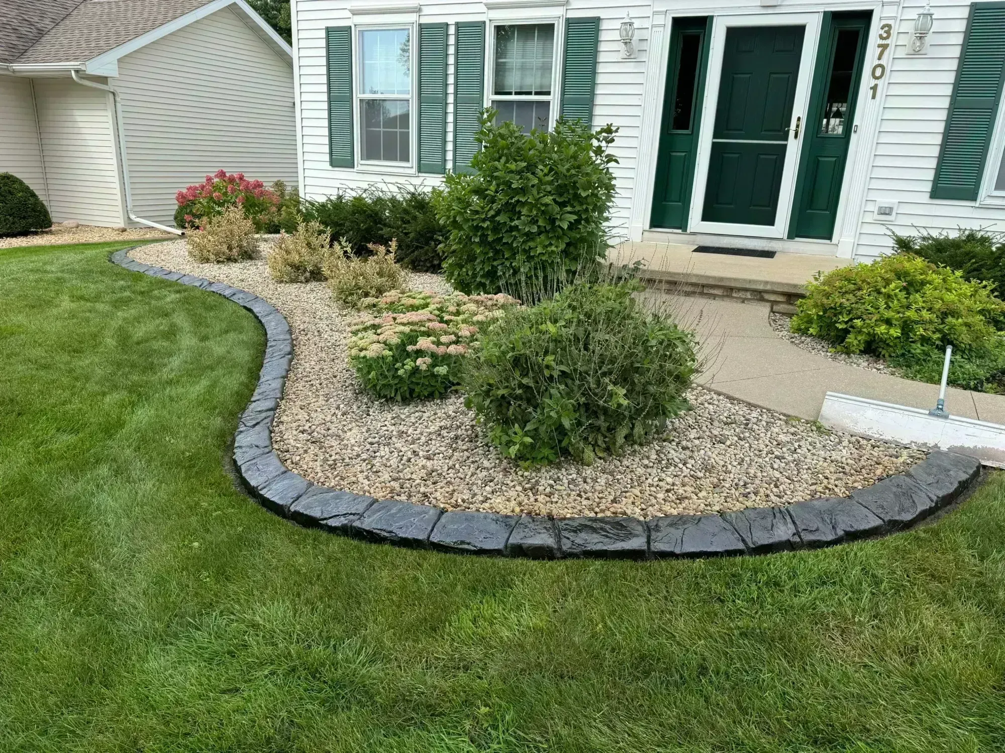 Concrete landscape curbing along a garden bed in Three Lakes, WI Concrete landscape curbing along a garden bed in Three Lakes, WI